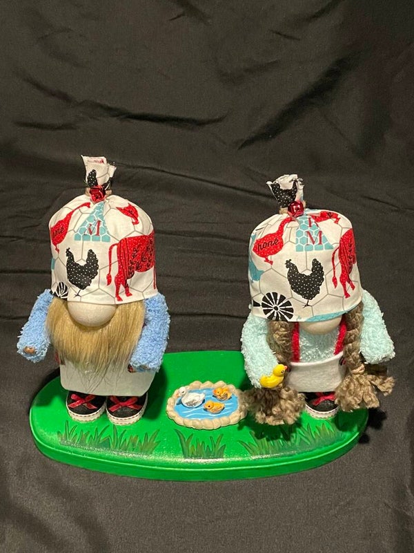 Farm gnome with ducks in pond