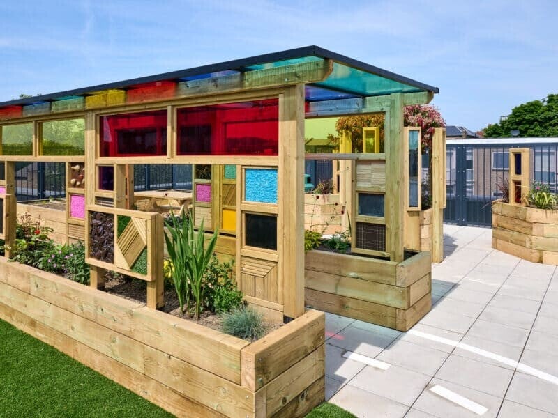 Coloured roof, light and tactile pergola for sensory garden space