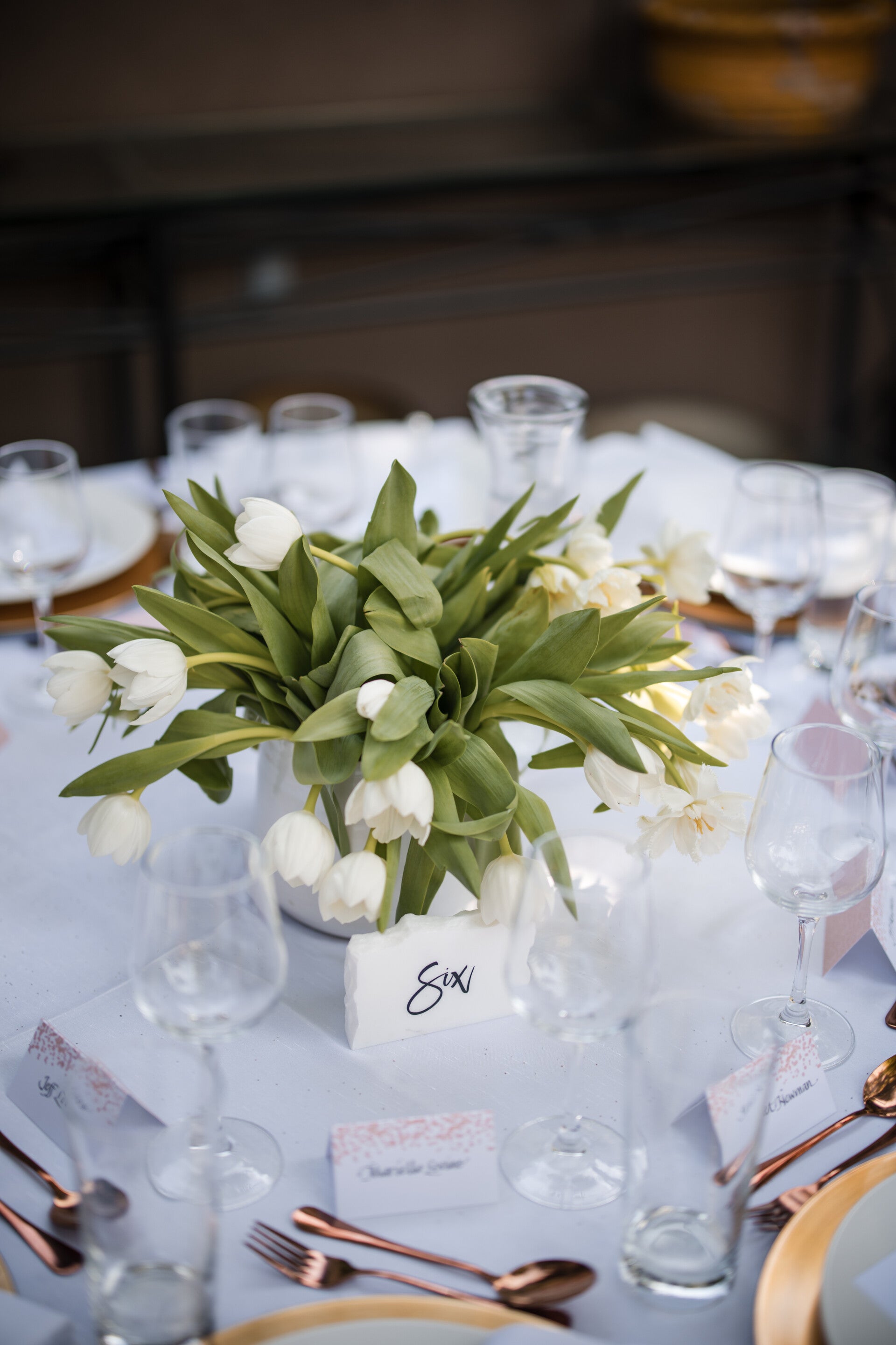 Elegant white floral centerpieces and wedding table decor designed by Shelley Whizin’s event production team.