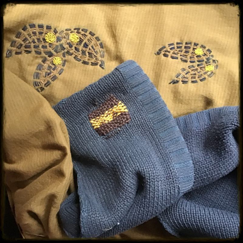 Visible mending on sweater and skirt.