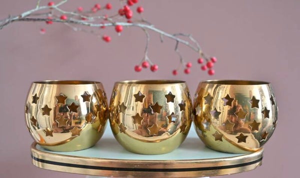 Drie waxinelichthouders met sterretjes