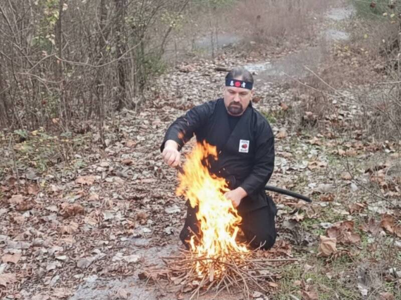 Bobby Calvert AKA Ninja Bob builds a fire at Ninja Camp 