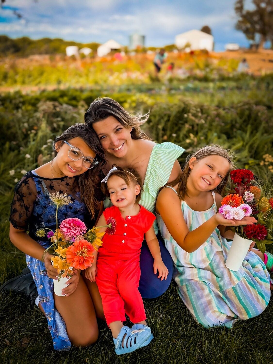 Rachel and her three girls with flowers in a Treasure Valley field