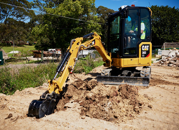 Mini Digger and driver hire Tiverton. Trench digging