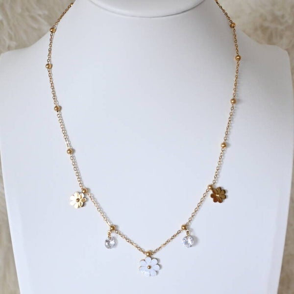 Fijne goudkleurige ketting met witte bloemetjes en steentjes