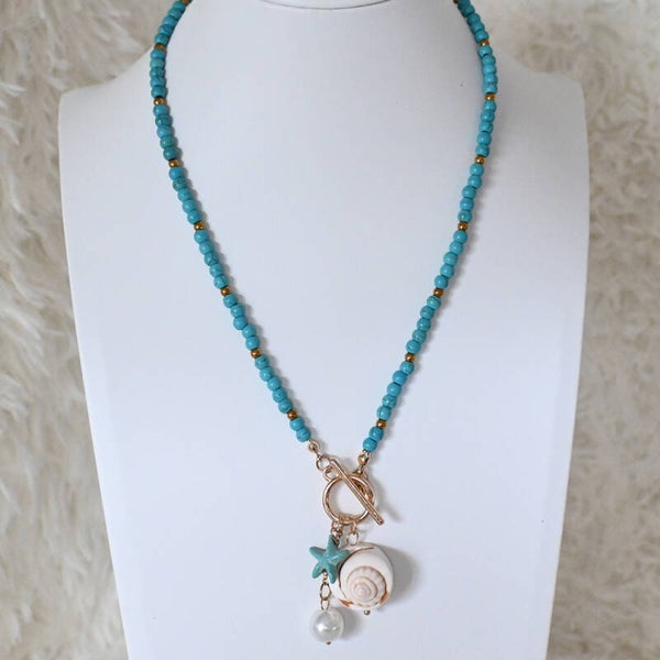 Zomerse turquoise bedelketting met schelp