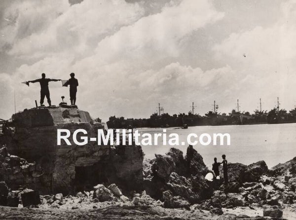 Original WW2 US Press Photo - US Signalman directs landing ships off Okinawa, Japan (1945)