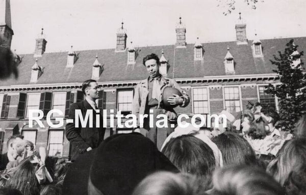 Original WW2 Dutch Liberation Press Photo - US soldier celebrating by the Buitenhof in The Hague (1945)