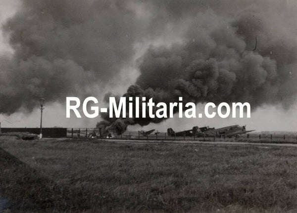 Original WW2 German Photo - Burning Fokker G1 next to landed Junker JU 52 airplanes at the Rotterdam airfield Waalhaven, Holland, May (1940)