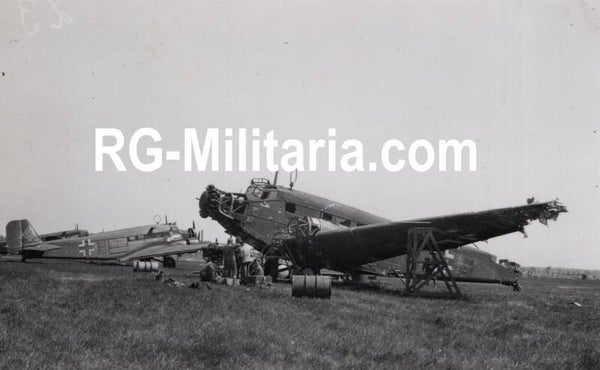 Original WW2 German Photo - Luftwaffe mechanics working on damaged Junkers JU 52 airplanes at the Rotterdam airfield Waalhaven, Holland (1940)