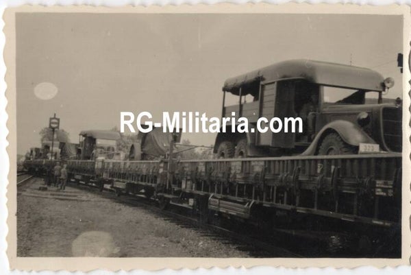 Original WW2 German Photo - Captured Dutch army trucks and canons on a train, Holland, May (1940)