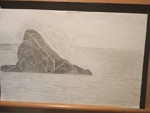 water crashing onto a rock in the ocean