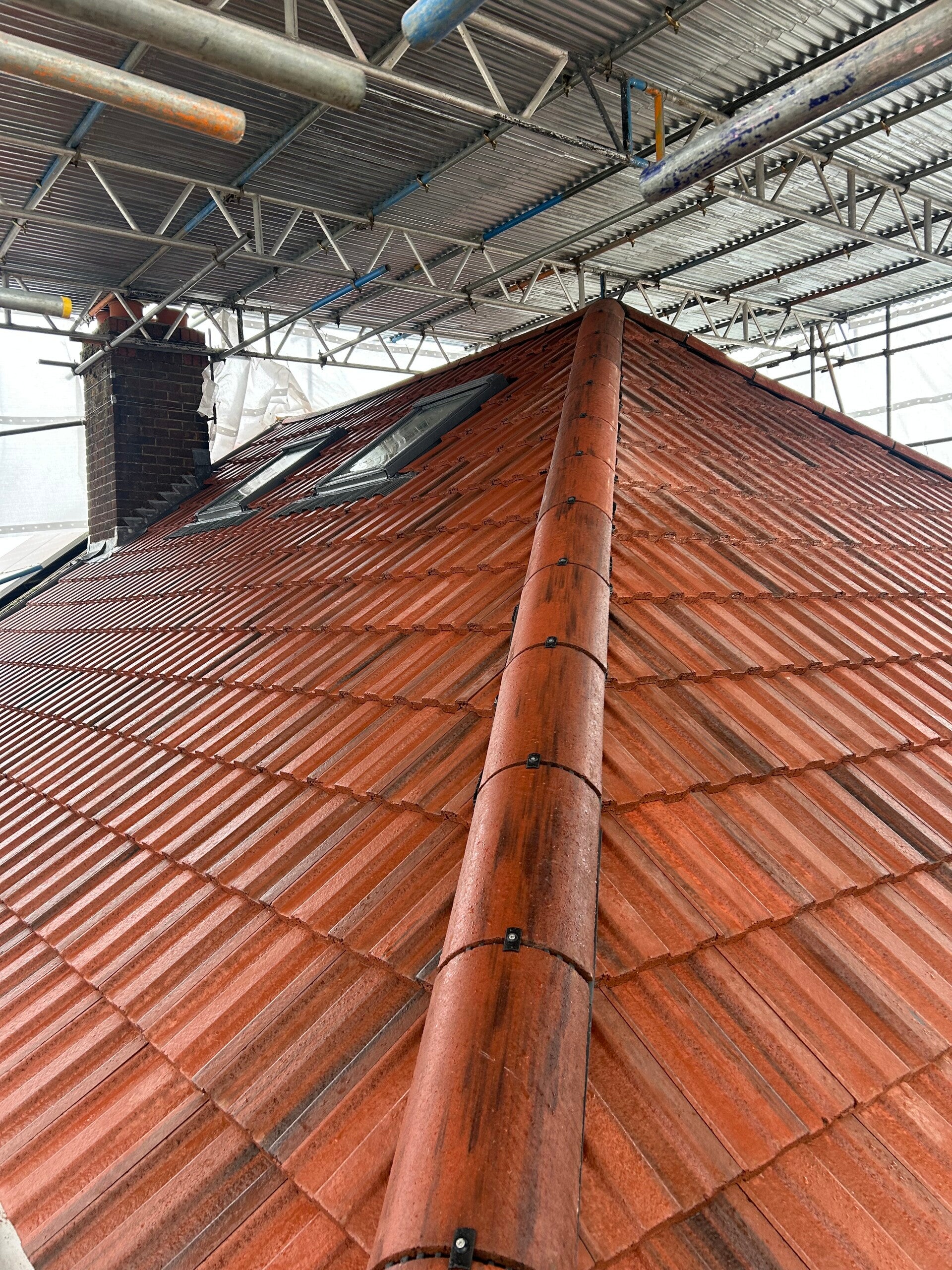 Roof structure covered with purple breathable roofing membrane and timber battens prepared for tile installation