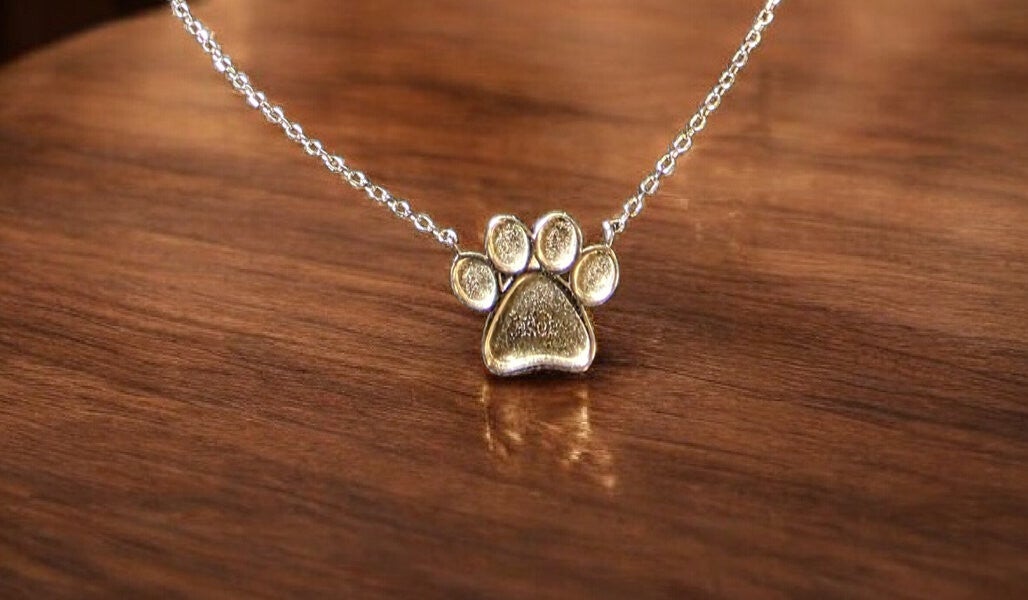 Hondenpoot hanger zilver – vulbaar met as, aarde of moedermelk