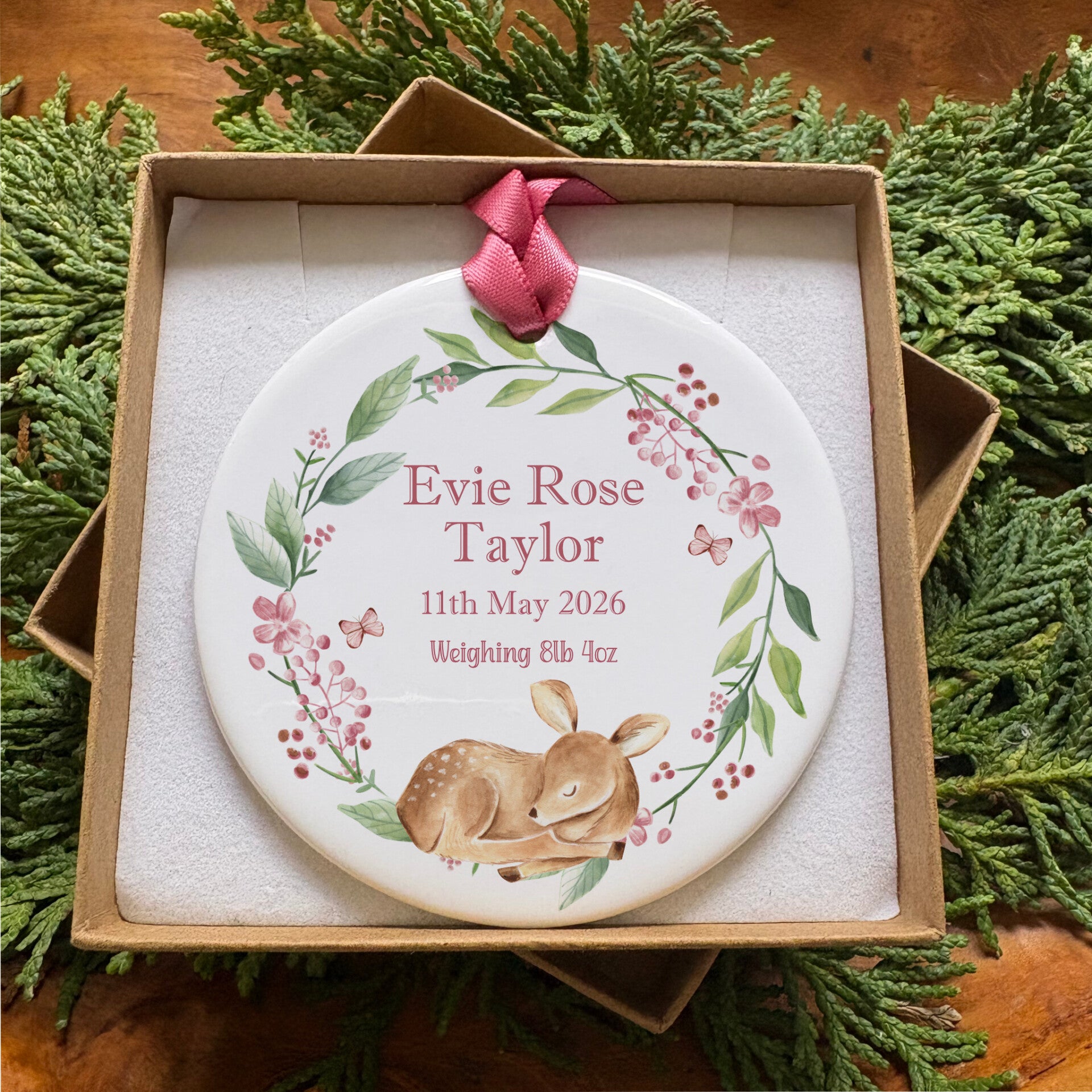 Our collection of personalised keepsake gifts for new babies. This image shows our pink floral fawn design, with green and pink foliage and a sleeping fawn, the centre has the recipients name and birth details