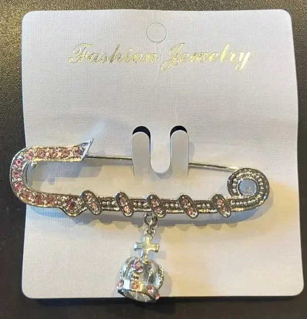 Broche argentée et rose épingle à nourrice avec croix et couronne
