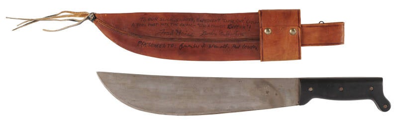 "Universal Cutter" machete-style knife and leather sheath presented to Guenter Wendt by ALT crew members Fred Haise and Gordon Fullerton. Haise and Fullerton comprised the first crew for the Space Shuttle Approach and Landing Tests.