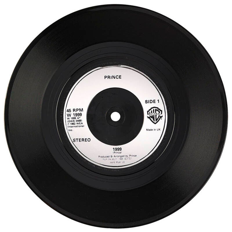 Warner Bros. 45 RPM single record of Prince's popular tracks '1999 / Little Red Corvette,' signed and inscribed on the reverse in black felt tip, "Love God, Prince."