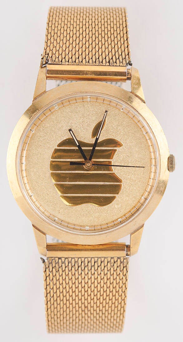 Gold-tone Apple Computer wristwatch by Josten's, featuring the golden Apple logo on a plain 35mm dial