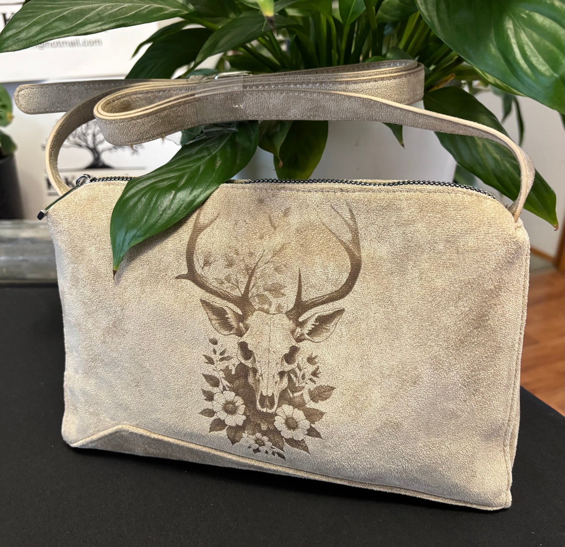 Deer Scull and flowers laser etched, light beige suede style cross body bag.
