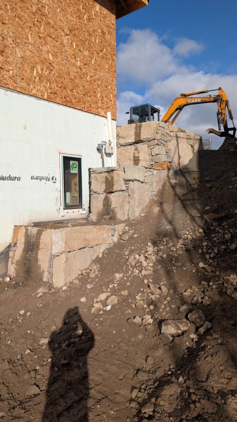 Natural rock wall beside new construction (work in progress)