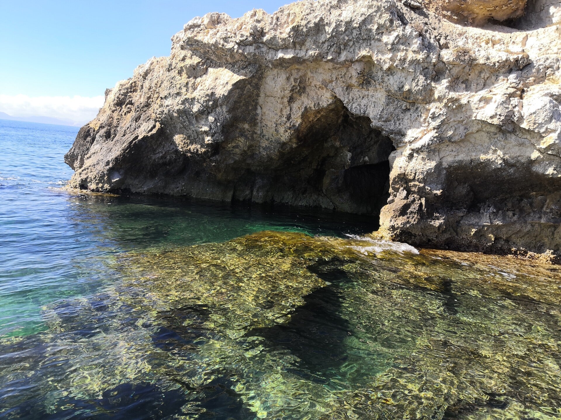 Sea cave and crystal-clear waters at the Devil’s Saddle in Cagliari, Sardinia.
