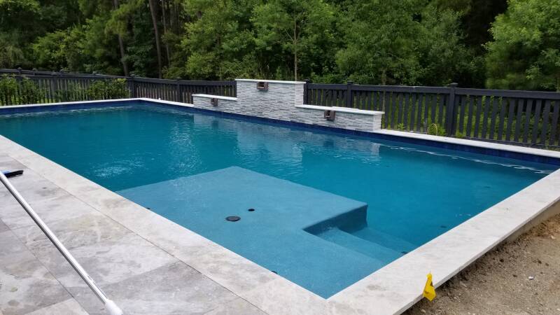 fence, travertine pool decking, landscape lighting