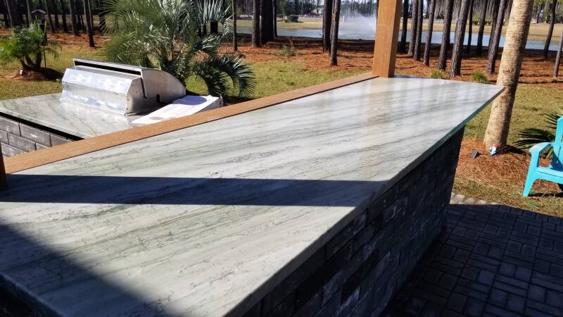 marble countertop with ironwood bar and pergola
