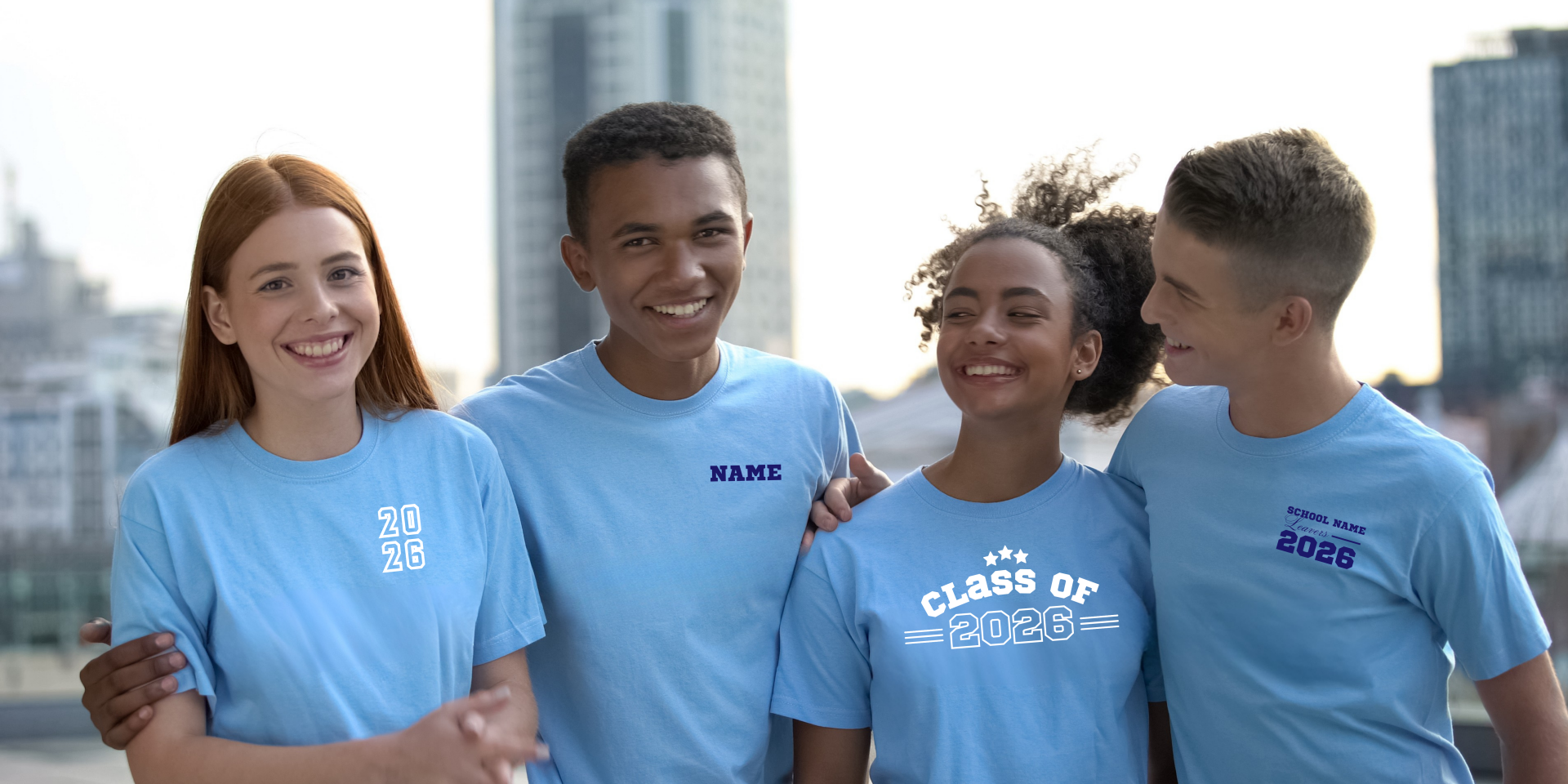 Group of students wearing light blue Class of 2026 Leavers T-shirts featuring various custom front-chest print designs including school names, student names, and large '26' graduation logos.
