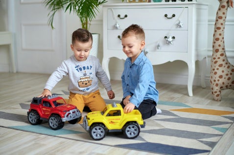 schemes in early years, children playing on the floor with cars