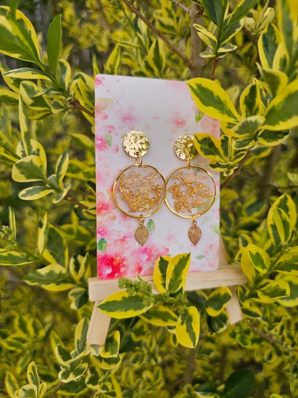 Boucles d'oreilles avec éclat d'or et sa plume