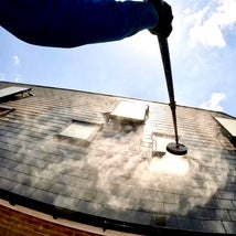 A house roof with two skylights and a solar panel cleaned by ReDy window cleaning