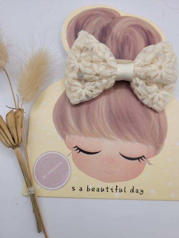 Een beige strik ( haarbandje )