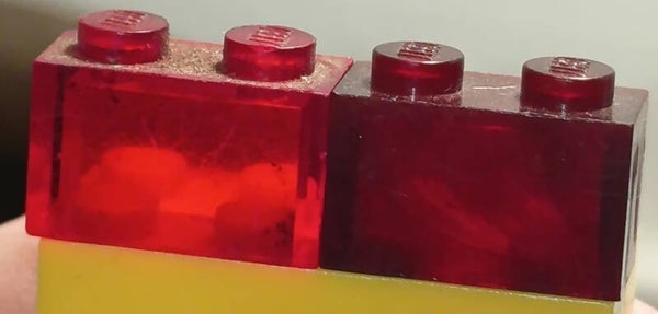 1x2 brick in trans red (dark)