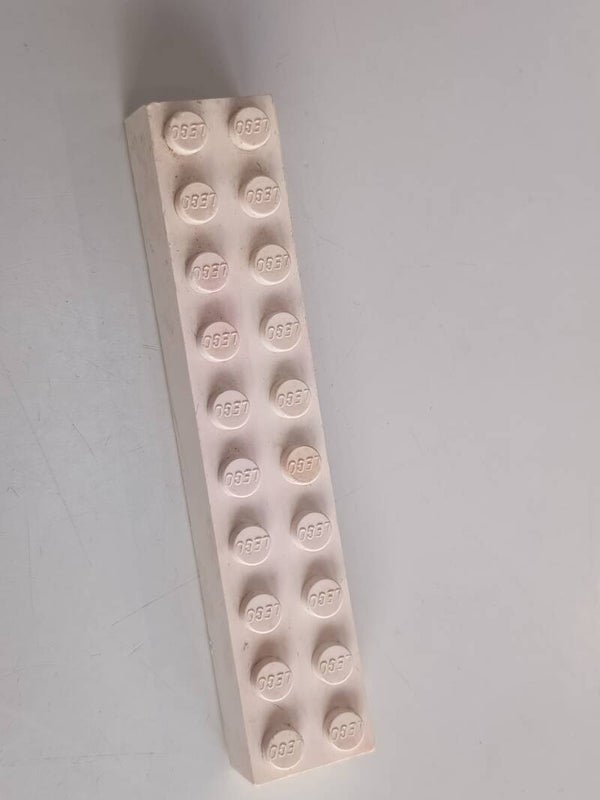 White 2x10 brick with some red.
