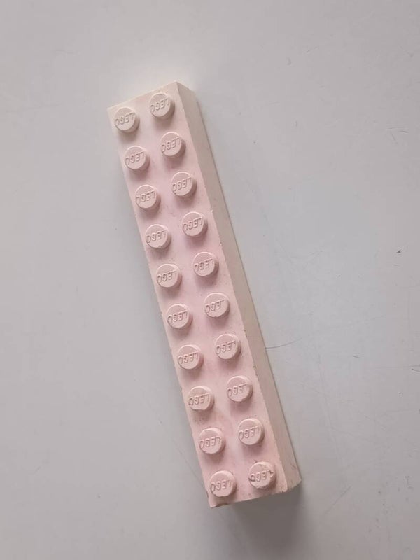White 2x10 brick with some red.