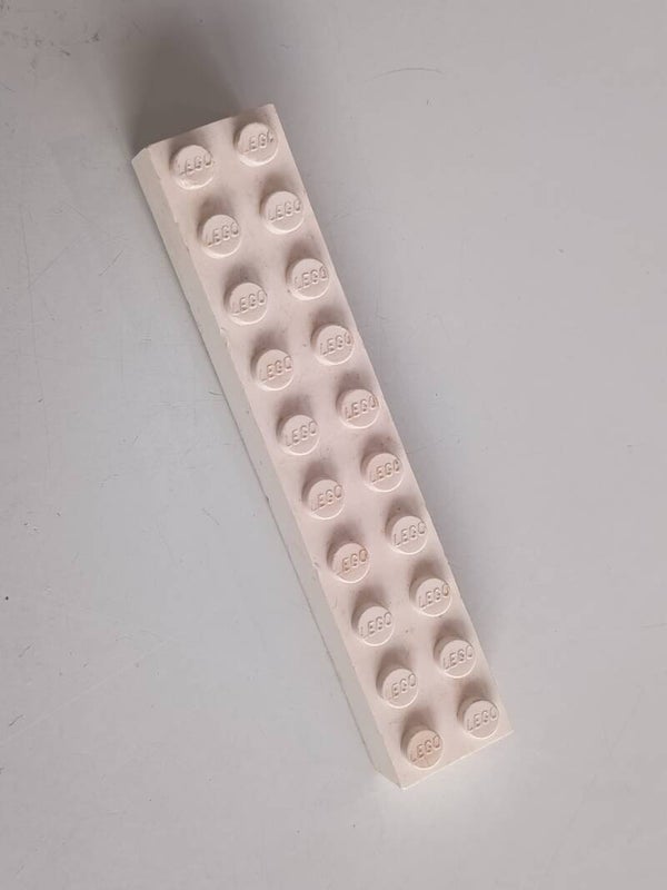 White 2x10 brick with some red.