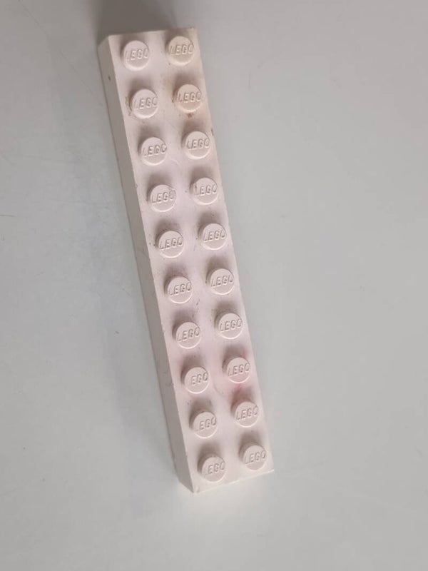 White 2x10 brick with some red.