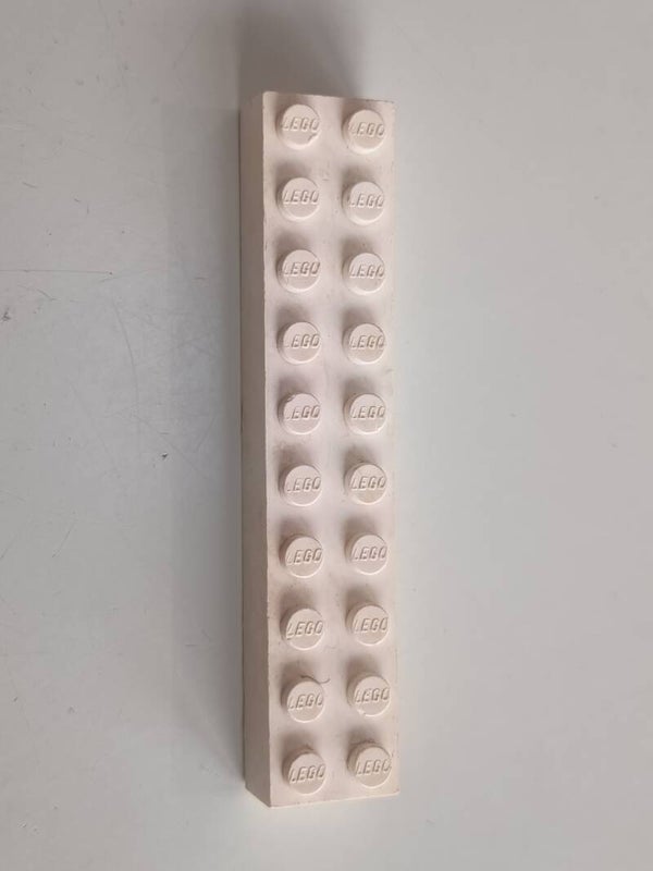 White 2x10 brick with some red.
