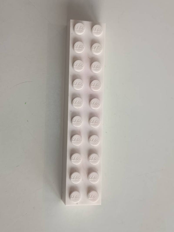 White 2x10 brick with some red.