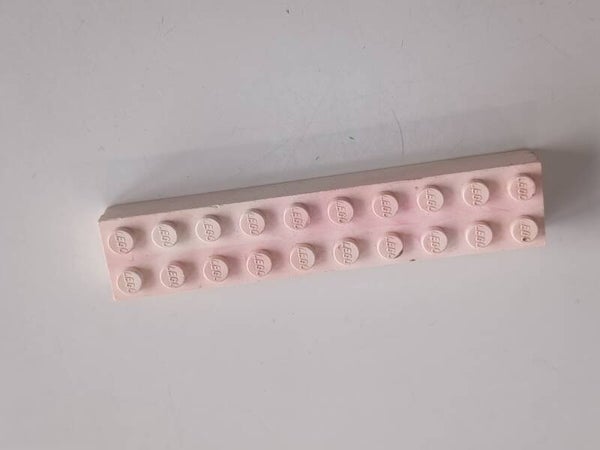 White 2x10 marbled brick with some red.