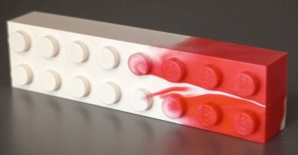 White 2x8 marbled brick with some red.