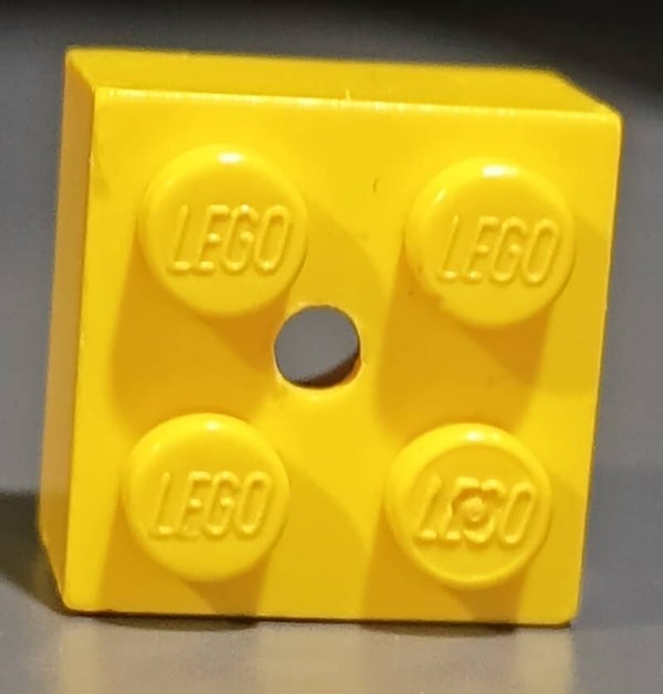 Yellow brick 2x2 with hole