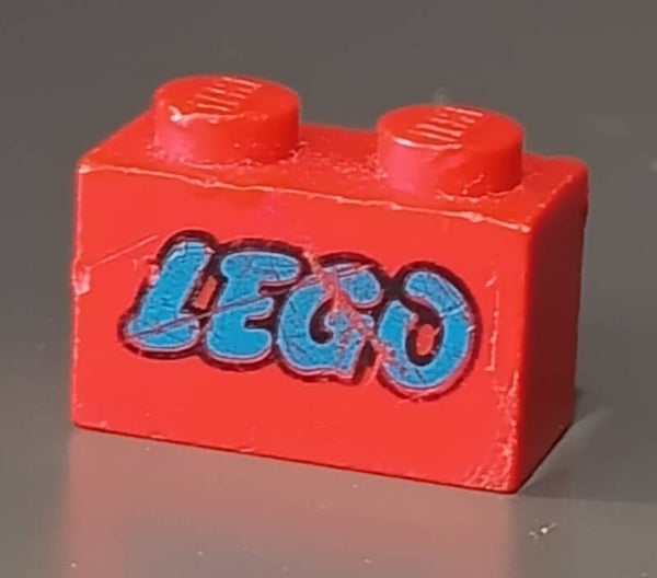 Red 1x2 brick with blue lego logo