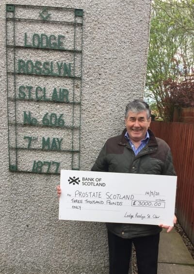 Bro. Alex Barrett PM DSM with a cheque for £3000 raised by him for Prostate Scotland.
