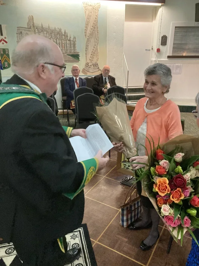 Harry's wife Helen being presented with flowers
