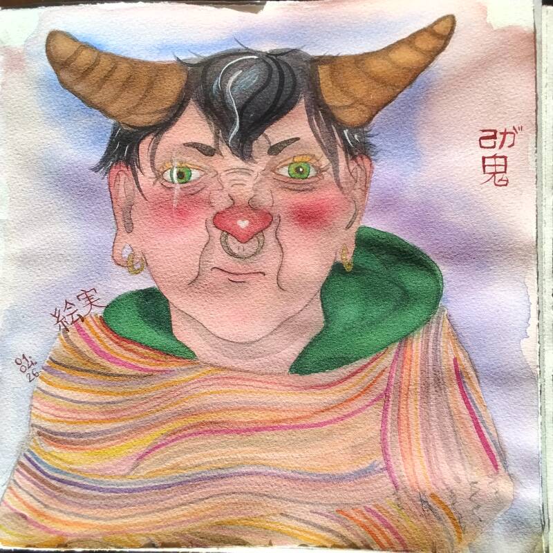 A woman with cow horns wearing a striped scarf around her shoulders 