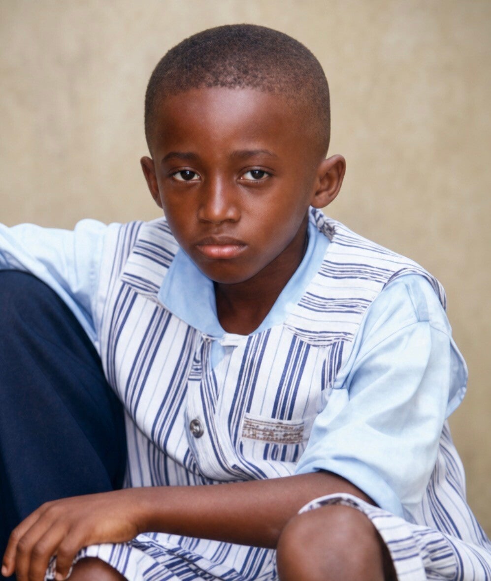 Ahmed Dadzie as a little kid staring into the camera 