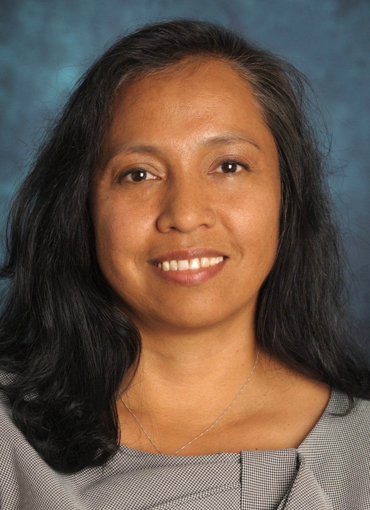 Juanita smilining in a photo