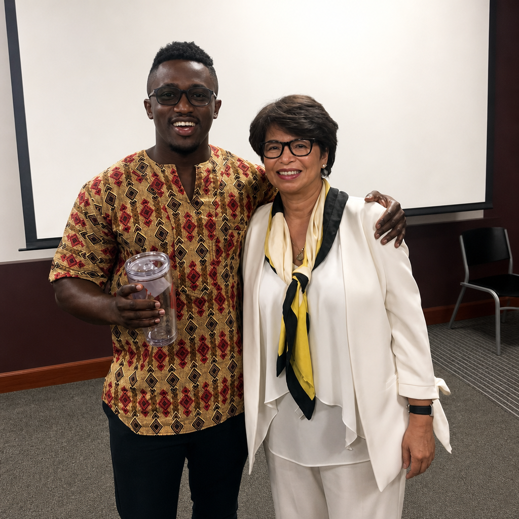 Ahmed Dadzie Health and Human Services Director and Friend Valerie Jarrett smiling in photo 